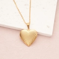 Golden heart locket necklace with wheat pattern on a textured stone display - Gold Shimmer Waves (29*29mm)