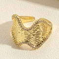 Macro detail of golden wave ring with pleated texture and sparkling zircon inlay - JZ0317-3 Wave Zirconia Open Ring / Wave Zircon