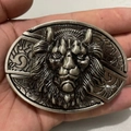 Detail of vintage silver lion head belt buckle with intricate 3D embossed metal carving - Lion Head