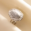 Macro detail of adjustable silver-tone ring with oval white stone on satin background - Silver-White Turquoise
