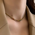 Close-up of gold-tone snake chain necklace with colorful zircon stones on female neck - Gold Rainbow Rhinestone Necklace