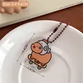 Cute acrylic capybara keychain with yellow skateboard and brown bead chain decoration - Skateboard Capybara