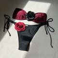 Detail of burgundy bikini top with 3D black rose and side-tie bottoms with red rose - Burgundy