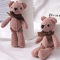 Pinkish-brown crochet teddy bear charms with brown ribbon bows shown in two poses - Pink