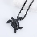 Detailed close-up of a black turtle pendant on a decorative white coral stone stand - With 60cm Box Chain / Black