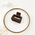 Close-up of matte brown square hair claw clip placed on a decorative ceramic plate - Dark Coffee