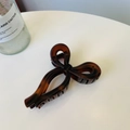 Detail of tortoise shell butterfly hair claw showing internal spring and amber texture - Matte Red Brown