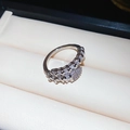 Macro shot of silver snake-shaped ring with pavé-set zircon stones in a jewelry box - Silver Snake Style