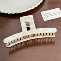 White marble texture acetate hair claw clip with golden metal spring on wood background - T-Shape Hair Claw