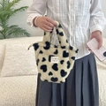Close-up of fluffy winter handbag with heart polka dots and branded woven label - Champagne Hearts
