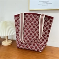Detail of red knitted tote bag with geometric diamond pattern and striped shoulder strap - 13 Rain Line Grid Wine Red