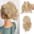 Short wavy claw clip ponytail extension in light blonde with natural fluffy curls - Champagne Blonde (18-613)