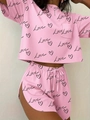 Detail of pink lounge set with black heart and Love prints showing crop top and side slit shorts - S / Pink Heart