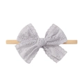 Detailed view of baby headband with grey lace bow and beige elastic nylon fabric - Light Gray