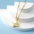 Minimalist gold bubble X-shaped letter necklace with a fine chain on white display - Letter X(X)