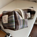 Detailed close-up of soft plaid wool fabric texture and white label on the cosmetic bag - Blue and Coffee Large Plaid