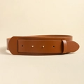 Close-up of brown leather wide belt with double eyelets and metal buckle detail - Camel