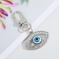 Silver metal Evil Eye keychain with sparkling rhinestones and a lobster clasp attachment - Silver Hollow Slanted Eye