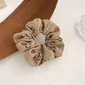 Detail of beige corduroy hair scrunchie with a black smiley face print pattern - Bubble Cotton Smiley Face / Khaki