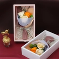 Detail of soap rose flower gift box with beige and orange petals and decorative ribbon - Orange K