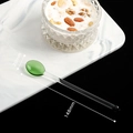 Green heart-shaped glass stirring spoon with transparent long handle and size measurements - Green