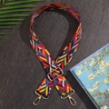 Adjustable colorful geometric pattern bag strap with gold metal hooks on stone background - Red/Geometric Pattern