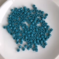 Macro view of scattered teal cylindrical acrylic spacer beads for DIY jewelry making crafts - 11# Blue Green