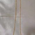 Delicate golden stainless steel chain necklace displayed on smooth white silk fabric - Flower Chain / Gold