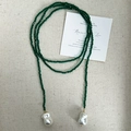 Macro detail of long green faceted spinel beads and baroque pearls on linen fabric - Green Spinel Necklace / 120cm / Green