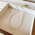 Detail of beaded necklace with beige faceted beads and white pearls in a jewelry box - White Seed Beads Pearl