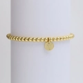 Close-up of a gold-plated beaded bracelet with a polished circular 'Y' letter pendant - Letter Y (DB240603-Y)