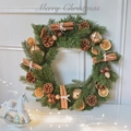 Rustic Christmas wreath with pine needles, pinecones, cinnamon sticks and golden bells - Bell