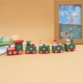 Detailed view of a Christmas wooden train with snowmen and trees on a yellow background - Green (5 sections)