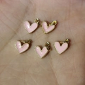 Five pink enamel heart charms with gold beaded edges for DIY jewelry crafting and necklaces - Pink