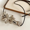 Detail of silver tulip pendant on black leather cord displayed on a canvas jewelry tray - Tulip Flower Waist Chain (WN1213) / Silver