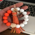 Llavero de pulsera de silicona con cuentas geométricas de madera y borla de cuero naranja - Naranja