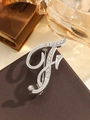 Elegant silver-toned letter F brooch with sparkling clear crystals on leather surface - Silver Letter F