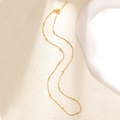Detail of gold beaded necklace with delicate thin chain and lobster clasp closure - A0161 Interspersed Bead Chain