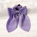 Detailed view of a purple silk satin oversized bow scrunchie on a French style background - Purple