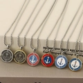 Detail view of nautical compass pendants with anchor design in six color variations - Anchor Style B / Steel Black