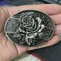Detail of 3D embossed rose on vintage silver belt buckle with intricate metal leaves - Western Rose
