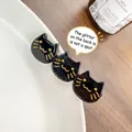 Chic black acetate hair clip with three gold-lined cat faces and a glossy finish - 6.5cm / Black