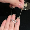 Close-up of a silver pavé-set horseshoe buckle bracelet with a delicate O-link chain - Silver