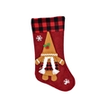 Macro view of festive Christmas gingerbread gnome stocking featuring red plaid decor - Red
