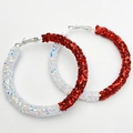 Close-up of oversized hoop earrings with shiny white and red sequins for sports events - Red and White