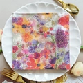 Square party napkin featuring vibrant floral patterns displayed on a lace-trimmed plate - Colorful Floral (1114)