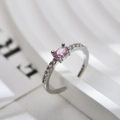 Macro view of a silver ring with an oval pink gemstone and small white zircons - Adjustable Open / Silver Color Pink Zirconia Ring