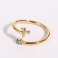 Detailed close-up of gold Aries zodiac ring with a sparkling blue round gemstone - Aries - Gold