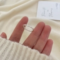 Minimalist silver 925 twisted wave ring worn on finger against beige background - Twisted Wave Silver Style(JZ0021)
