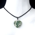 Green natural stone heart pendant necklace with black cord on mannequin - Auspicious Jade